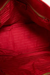 Close-up interior of a red textured fabric with a brand label.
