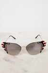 Sunglasses with flame details on a light background