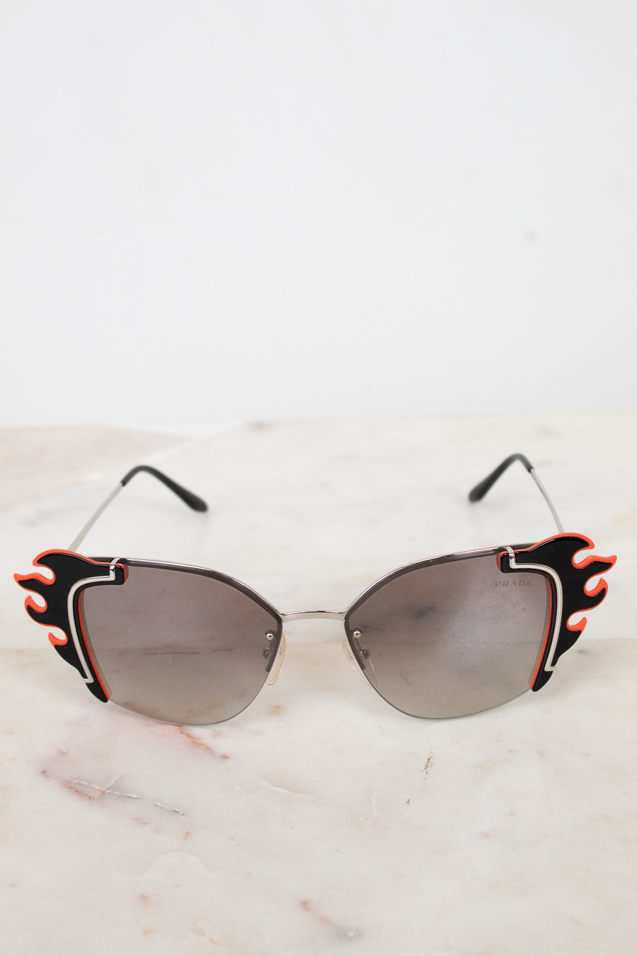 Sunglasses with flame details on a light background