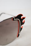 Sunglasses with flame-like ends on a white background