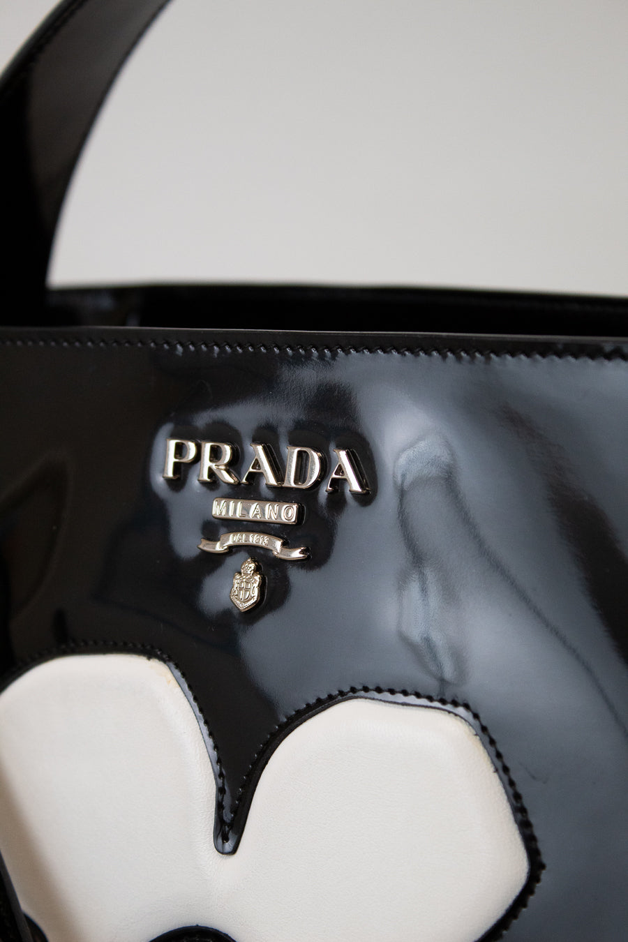 Close-up of a Prada handbag with a blurred background