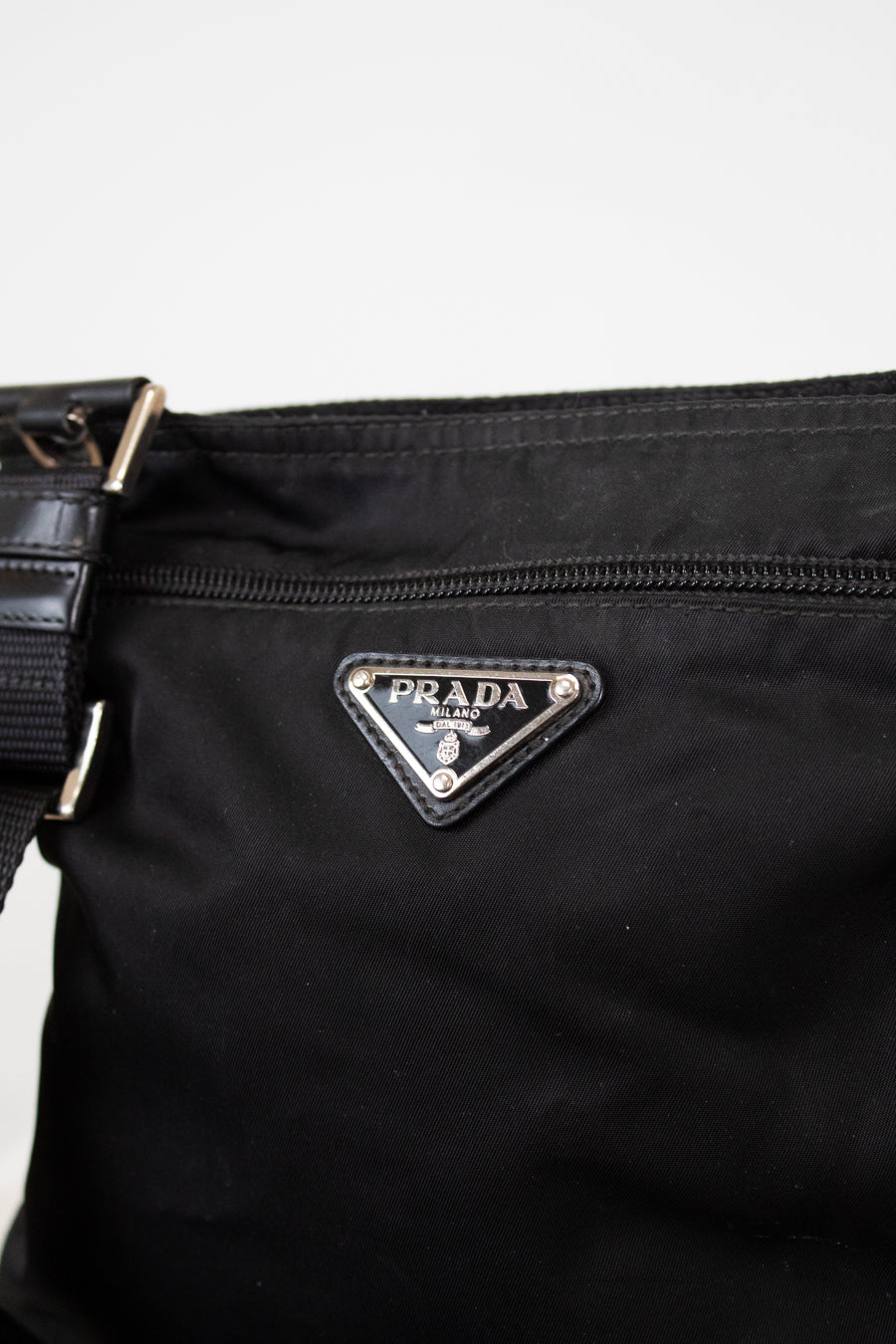 Black Prada bag with logo on a light gray background