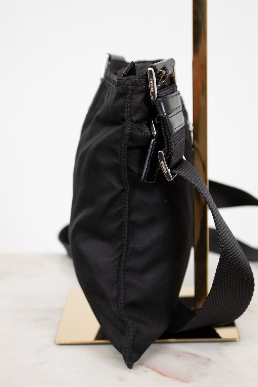Black bag with a strap on a white surface