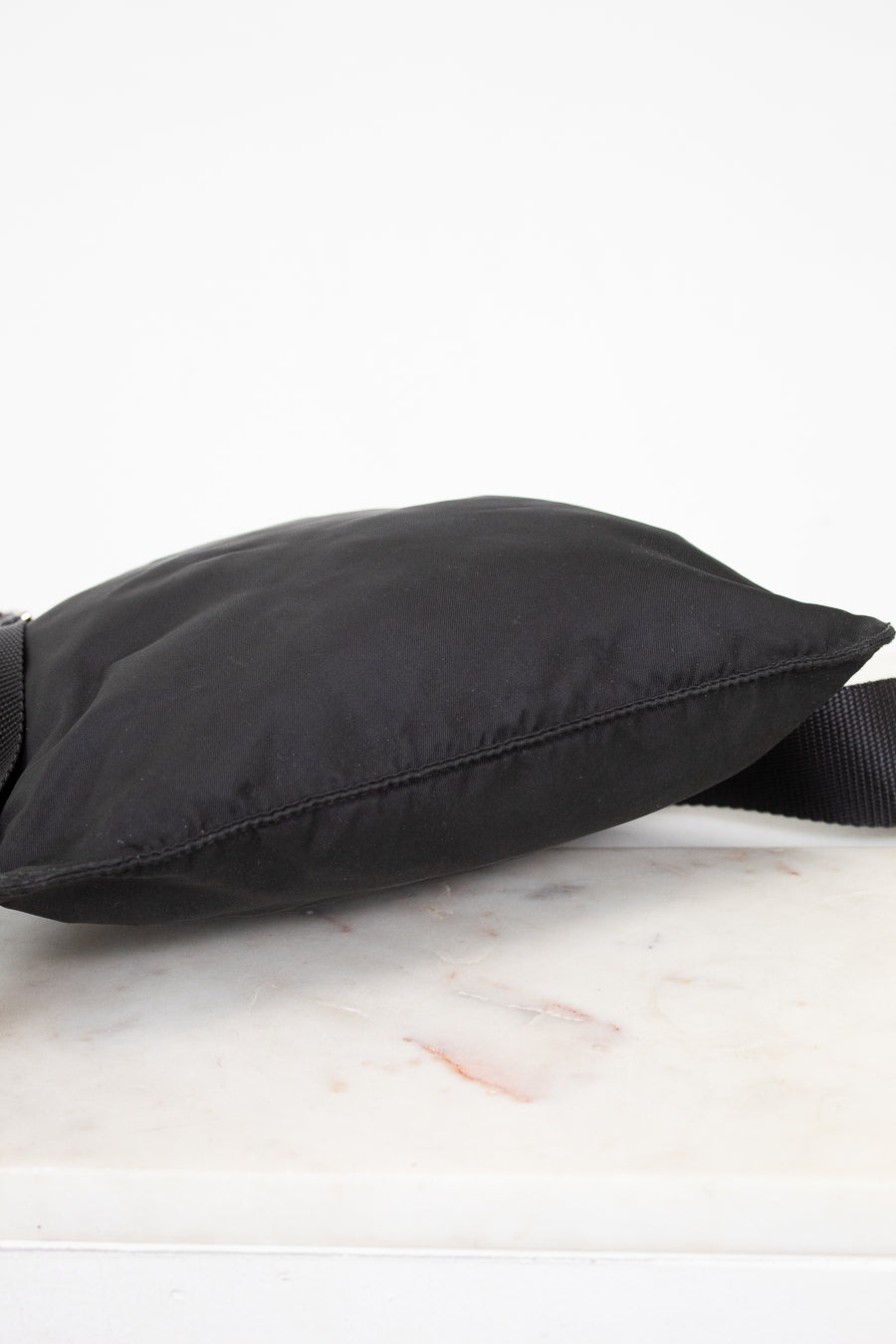 Black bottom of nylon bag on a marble surface