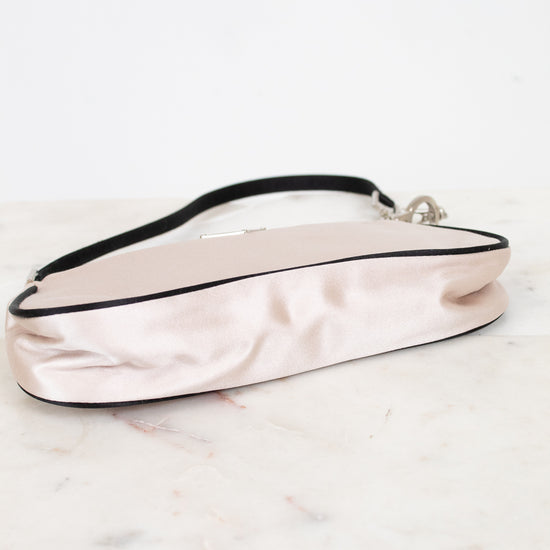 Pink satin handbag on a marble surface