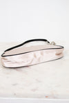 Pink satin handbag on a marble surface