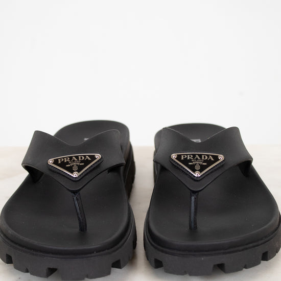 Black Prada sandals on a light background