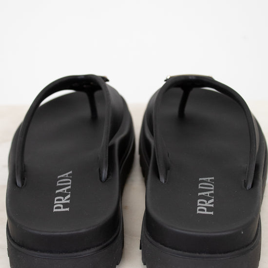 Black Prada sandals on a white background