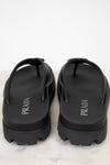 Black Prada sandals on a white background