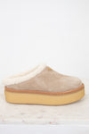 Beige slipper with white shearling lining on a light background