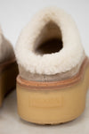 Close-up of a Prada shoe with white shearling lining and gum sole.