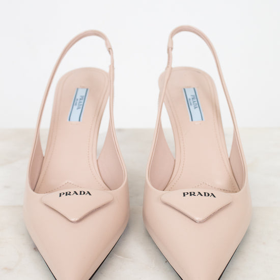 Pair of nude Prada high heels on a light background
