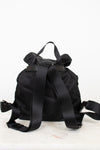 Back view of black nylon backpack showing adjustable straps and top handle displayed against a plain background