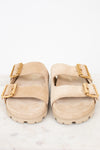 Beige sandals with gold buckles on a white background