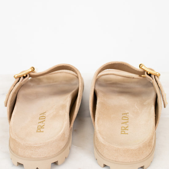 Pair of beige Prada sandals on a white background