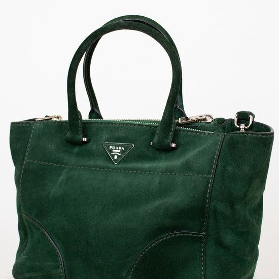 Green handbag with Prada logo on a white background