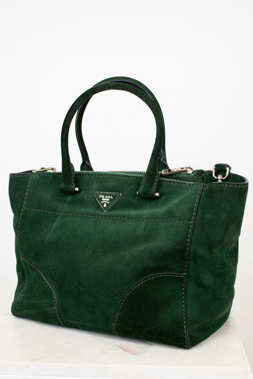 Green handbag with Prada logo on a white background