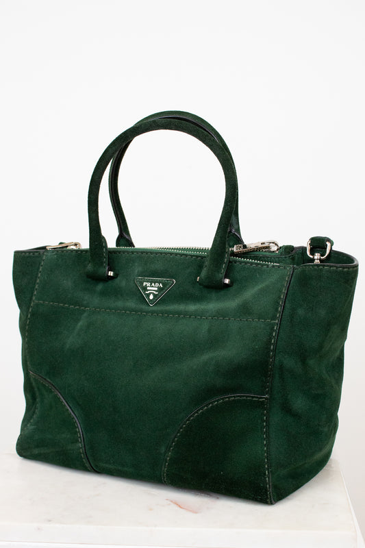 Green handbag with Prada logo on a white background
