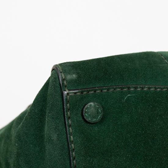 Close-up of a green purse with a button on a white background