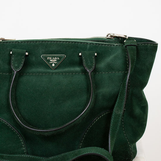 Green handbag with Prada logo on a white background