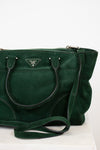 Green handbag with Prada logo on a white background