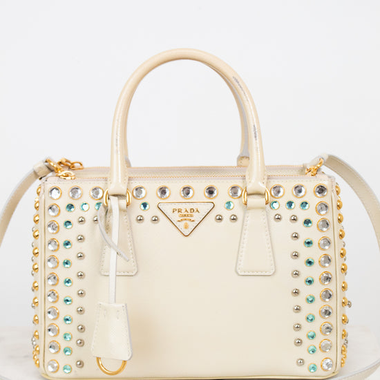 Decorative handbag with embellishments on a white background