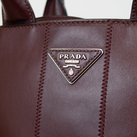 Close-up of a Prada handbag with visible branding.