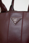 Close-up of a Prada handbag with visible branding.