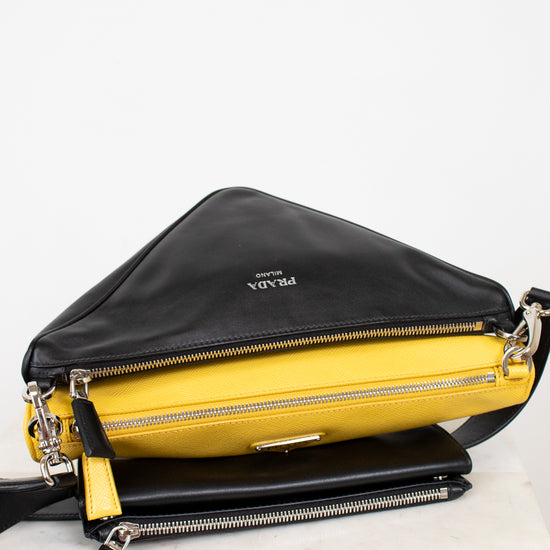 Black and yellow handbag with Prada logo on a white background