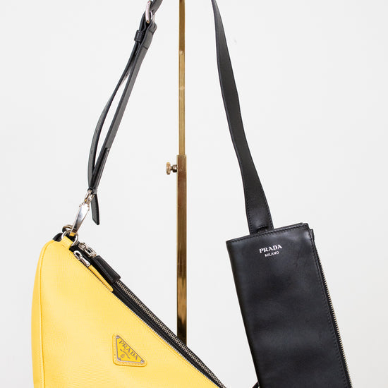 Yellow and black shoulder bag with a visible brand logo on a white background