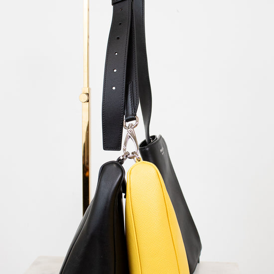 Black and yellow handbag on a white background