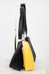 Black and yellow handbag on a white background