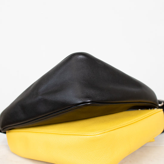 Black and yellow handbag on a white surface