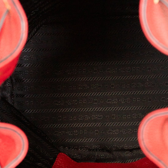 Close-up of a red handbag with a black interior
