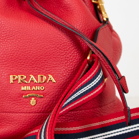 Red Prada handbag with gold logo on a light background