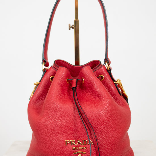 Red Prada handbag on a white background
