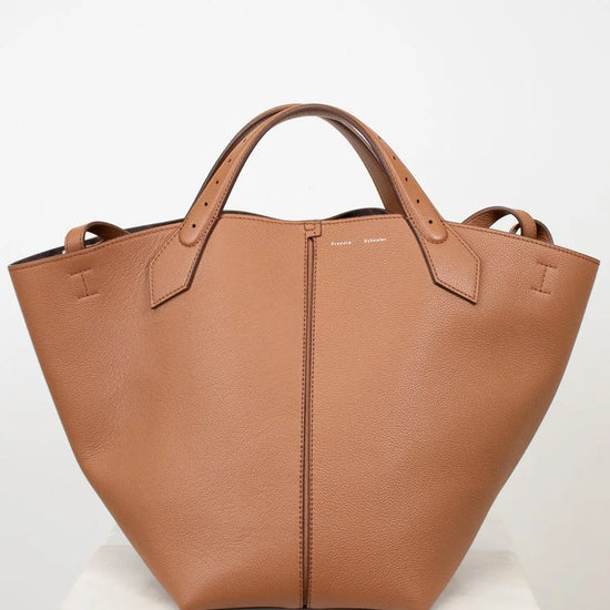 Brown leather tote bag on a white background