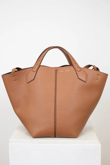 Brown leather tote bag on a white background