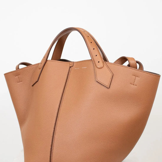 Tan leather tote bag on a white background
