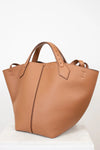 Tan leather tote bag on a white background