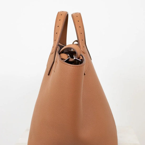 Brown leather handbag on a white background