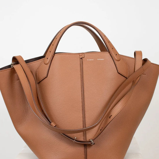 Brown leather handbag on a white background