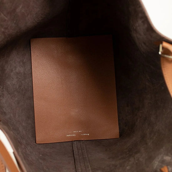 Brown leather bag interior with leather floor mat