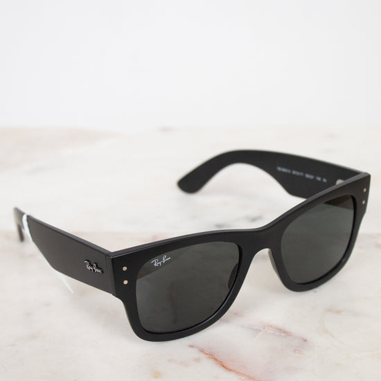 Black sunglasses on a light marble surface