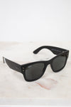 Black sunglasses on a light marble surface