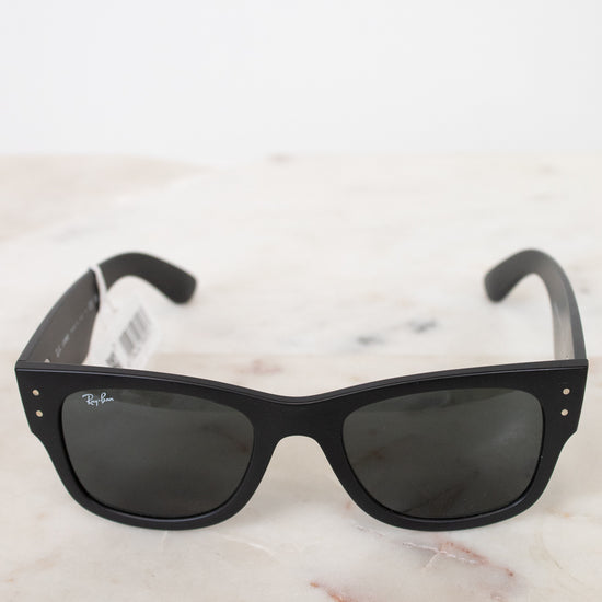 Black sunglasses on a white marble surface