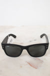Black sunglasses on a white marble surface