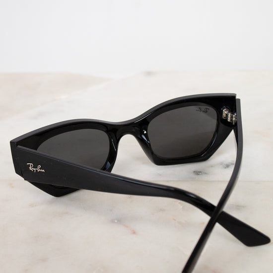 Black cat-eye sunglasses on a marble surface