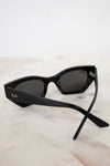 Black cat-eye sunglasses on a marble surface