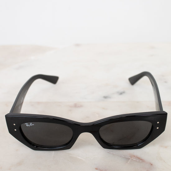 Black sunglasses on a marble surface